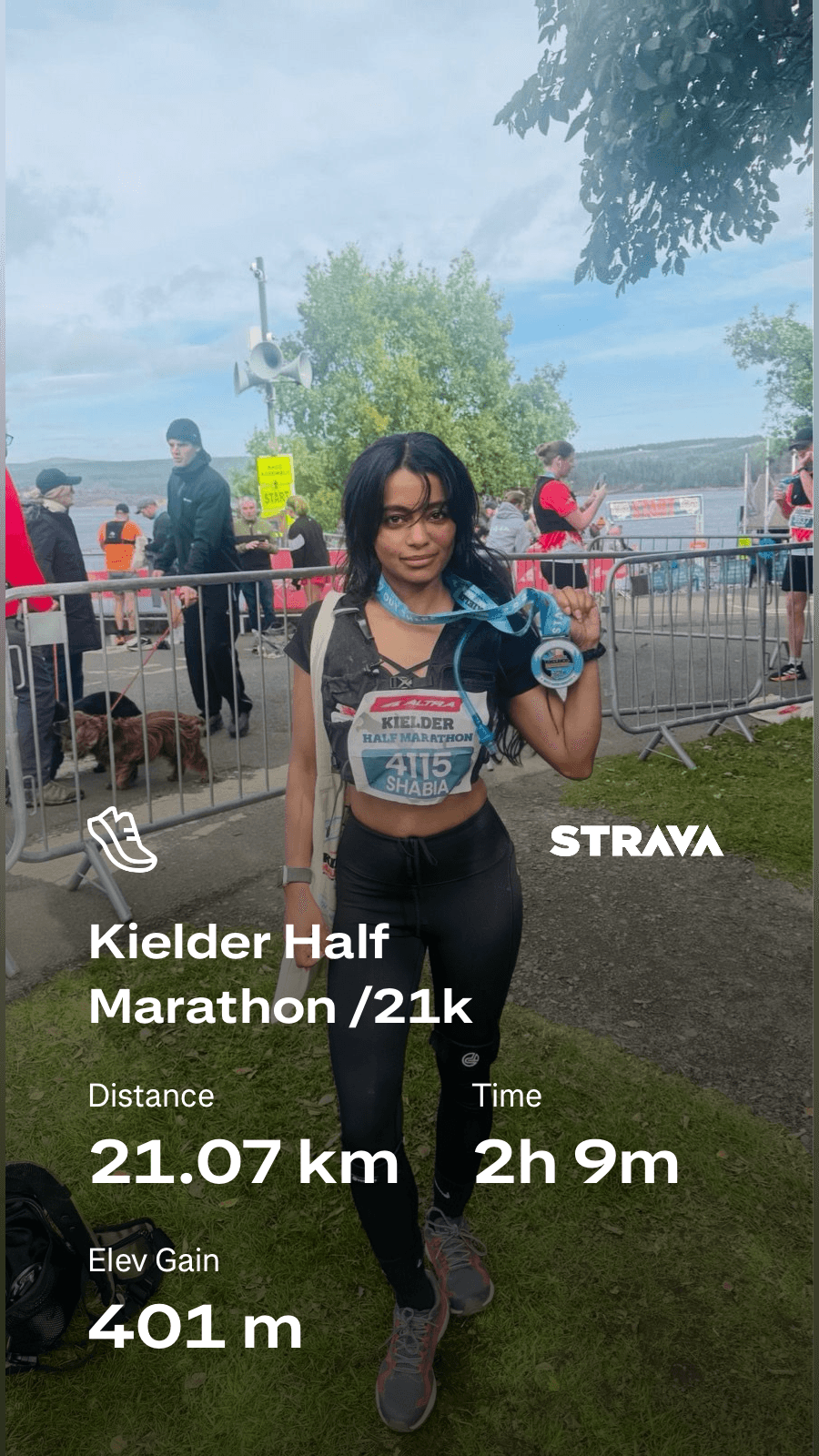 Finishing the Kielder Half Marathon with a medal, bib 4115