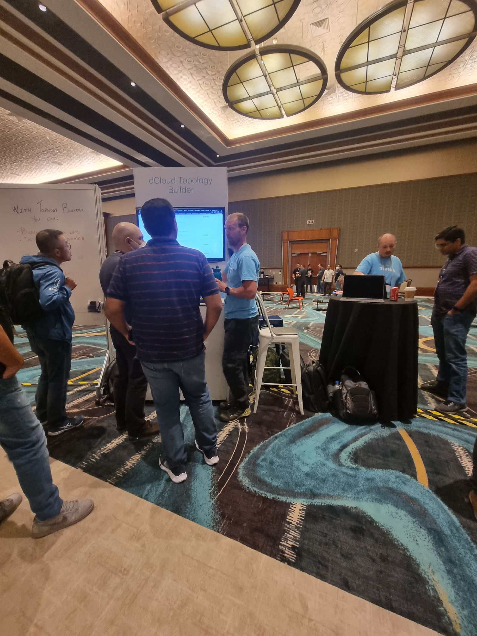 Attendees gathered around the Topology Builder booth display at Cisco Live